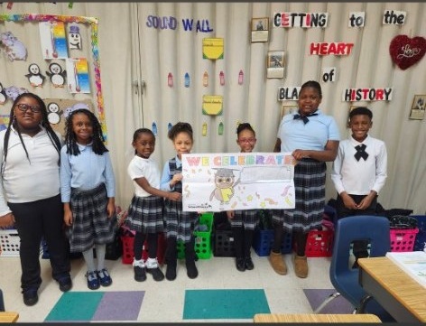 Students holding a We Celebrate banner